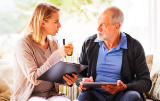 caregiver talking with senior man