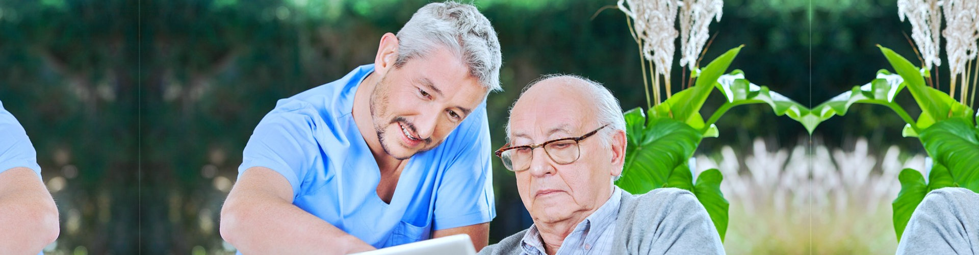 caregiver and senior man reading